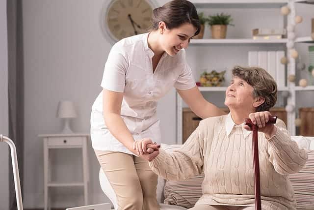 caregiver assisting an elderly woman